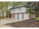 Two-story home featuring a three-car garage, brick accents, and mature trees on a spacious lot at 11351 Quivas Way, Denver, CO 80234
