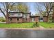 Charming front exterior of a two-story home with a well-manicured lawn and mature trees at 11351 Quivas Way, Denver, CO 80234