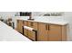 Bright kitchen island boasts white countertops and light wood cabinets at 11351 Quivas Way, Denver, CO 80234