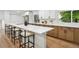 Modern kitchen featuring a large island with seating, quartz countertops, and stainless steel appliances at 11351 Quivas Way, Denver, CO 80234