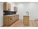 Contemporary kitchen with stylish cabinets, countertops, and an island with black hardware at 11351 Quivas Way, Denver, CO 80234