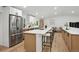 Modern kitchen with a large island, stainless steel appliances, and light wood accents at 11351 Quivas Way, Denver, CO 80234