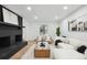 Bright, modern living room with brick fireplace, wood floors, and comfortable seating at 11351 Quivas Way, Denver, CO 80234
