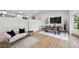Bright living room with wood floors, stylish furniture, and natural light at 11351 Quivas Way, Denver, CO 80234