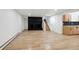 Spacious living room featuring a modern black fireplace, wood floors, and adjacent staircase at 11351 Quivas Way, Denver, CO 80234