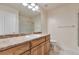 Bright bathroom features a shower-tub, vanity with storage, and neutral tile flooring at 22834 E Davies Dr, Aurora, CO 80016