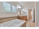 Bathroom featuring a large soaking tub, double vanity, and tiled floors at 22834 E Davies Dr, Aurora, CO 80016