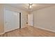 Bedroom boasts wood-look floors, double sliding-door closet, ceiling fan, and neutral colored walls at 22834 E Davies Dr, Aurora, CO 80016