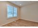 Bright bedroom featuring wood-look flooring and plantation shutters on the window at 22834 E Davies Dr, Aurora, CO 80016