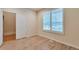 Bright bedroom featuring wood-look flooring and plantation shutters on the window at 22834 E Davies Dr, Aurora, CO 80016