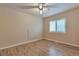 This bedroom has a window, wood-look floors, a ceiling fan, and neutral colored walls at 22834 E Davies Dr, Aurora, CO 80016