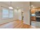 Bright dining room featuring hardwood floors, window with shutter, and stainless steel appliances in the nearby kitchen at 22834 E Davies Dr, Aurora, CO 80016