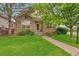 Charming stone-clad home with a well-manicured lawn and inviting walkway at 22834 E Davies Dr, Aurora, CO 80016