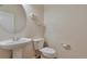 Powder room with pedestal sink, toilet, and modern fixtures at 22834 E Davies Dr, Aurora, CO 80016