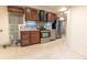A modern kitchen with stainless steel appliances, wood cabinets, and a stainless steel range hood at 22834 E Davies Dr, Aurora, CO 80016
