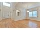 Bright living room featuring hardwood floors, high ceilings, and many windows providing plenty of natural light at 22834 E Davies Dr, Aurora, CO 80016