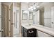Bathroom featuring a vanity with dark wood cabinets, mirrors, and lighting at 9823 Salford Ln, Highlands Ranch, CO 80126