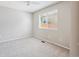 Empty bedroom featuring neutral carpeting, a window, and a ceiling fan at 9823 Salford Ln, Highlands Ranch, CO 80126