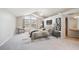 Stylized bedroom with a seating area, vaulted ceilings, and an attached bathroom at 9823 Salford Ln, Highlands Ranch, CO 80126