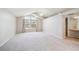 Spacious bedroom featuring vaulted ceilings, a ceiling fan, and an attached bathroom at 9823 Salford Ln, Highlands Ranch, CO 80126