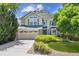 Inviting two-story home with a well-manicured front yard and a two-car garage at 9823 Salford Ln, Highlands Ranch, CO 80126