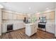 Spacious kitchen with stainless steel appliances, an island, and custom cabinetry at 9823 Salford Ln, Highlands Ranch, CO 80126