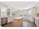 Bright kitchen with a center island, wood floors, and modern appliances at 9823 Salford Ln, Highlands Ranch, CO 80126