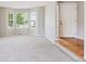 Bright living room with bay windows and plush carpeting at 9823 Salford Ln, Highlands Ranch, CO 80126