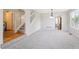 Open-concept living area with stairs, neutral tones, and modern lighting fixtures at 9823 Salford Ln, Highlands Ranch, CO 80126