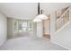 Spacious living room with large windows and plush carpeting at 9823 Salford Ln, Highlands Ranch, CO 80126