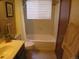 Bathroom featuring a shower-tub combination and a large window at 17671 E Brown Cir, Aurora, CO 80013
