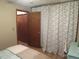 Neutral bedroom featuring a closet with a decorative curtain, door to a second closet, and light wood floors at 17671 E Brown Cir, Aurora, CO 80013
