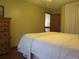 Bedroom with light pink bed, white curtains, wood floors, and dresser at 17671 E Brown Cir, Aurora, CO 80013