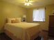 Bedroom with light pink bed, white curtains, wood floors, and dresser at 17671 E Brown Cir, Aurora, CO 80013