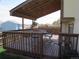 Spacious deck with covered area with overhead lighting and dark stained wood floor at 17671 E Brown Cir, Aurora, CO 80013