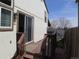 Exterior angle of deck with sliding glass door, light beige siding with dark brown trim and privacy fence at 17671 E Brown Cir, Aurora, CO 80013