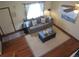 Upstairs living room features wood floors, natural light, and a comfortable sofa at 17671 E Brown Cir, Aurora, CO 80013