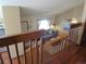 Bright living room features wood railing, vaulted ceiling, and neutral-toned decor at 17671 E Brown Cir, Aurora, CO 80013
