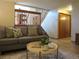 Living room with wood railing, comfortable seating, and plant on a small table at 17671 E Brown Cir, Aurora, CO 80013