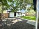 Charming backyard with mature trees, lush lawn, and a white painted home at 8873 Princeton St, Westminster, CO 80031
