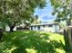 Expansive backyard with lush lawn, mature trees, and white painted home at 8873 Princeton St, Westminster, CO 80031