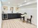 A complete entertaining space with bar, wine fridge, cabinets, a dining table, and chairs at 8873 Princeton St, Westminster, CO 80031