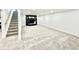 Expansive basement space with carpet, staircase, and fireplace, offering a versatile living area at 8873 Princeton St, Westminster, CO 80031