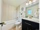 Bright bathroom featuring a shower over tub, and stylish vanity with gold hardware at 8873 Princeton St, Westminster, CO 80031
