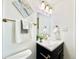 Stylish bathroom vanity with gold hardware, quartz countertop, and decorative mirror at 8873 Princeton St, Westminster, CO 80031