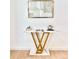 Modern console table with geometric gold base and marble top, featuring modern art at 8873 Princeton St, Westminster, CO 80031