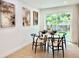 Aesthetic dining area with view to the yard through a sliding door, featuring paintings and light colored wood floors at 8873 Princeton St, Westminster, CO 80031