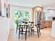 Charming dining area with light wood floors, modern table set, and view to the backyard at 8873 Princeton St, Westminster, CO 80031