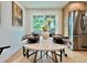 Bright breakfast nook features a dining table with a backyard view, as well as a modern stainless steel refrigerator at 8873 Princeton St, Westminster, CO 80031