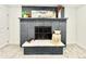 Painted brick fireplace with decorative mantel and hearth, adding a cozy focal point to the room at 8873 Princeton St, Westminster, CO 80031